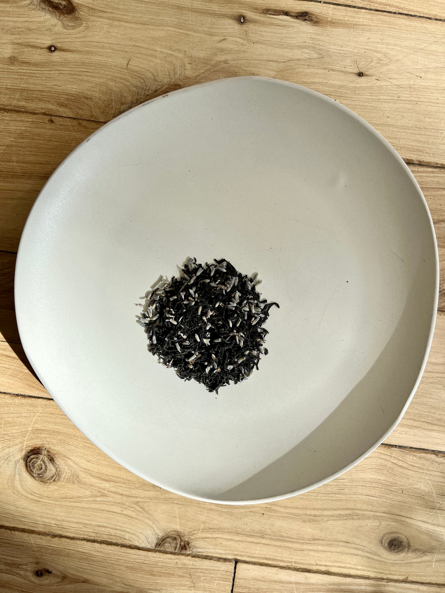 Photo of Uproot Teas' colorado-grown organic lavender blended with sri lankan single origin earl grey tea- black tea infused with bergamot on a plate
